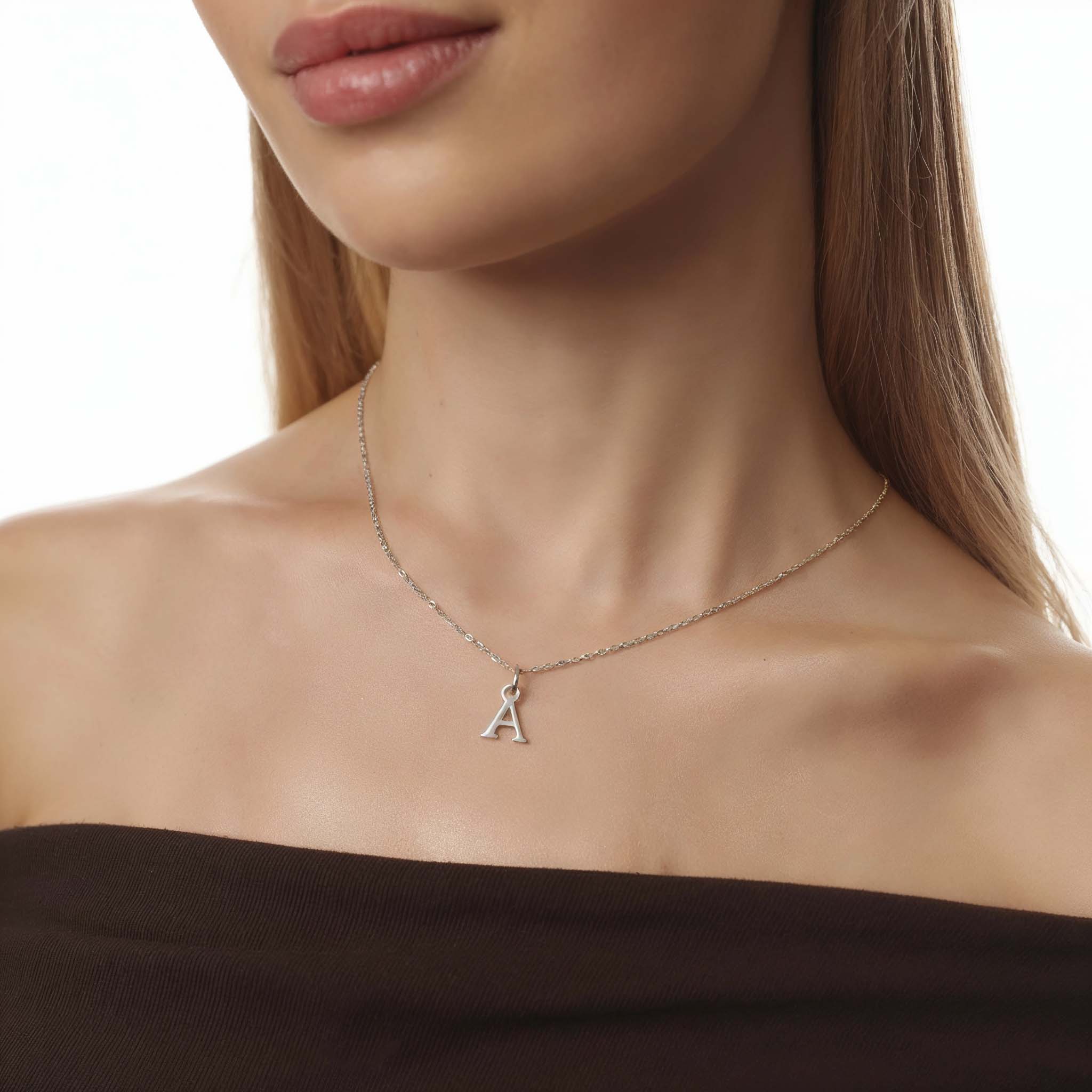Silver Necklace with a letter 'A' pendant on a model against a neutral background