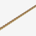 Gold bracelet with brown gemstones on a white background