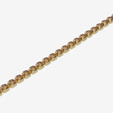 Gold bracelet with brown gemstones on a white background