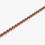 Gold bracelet with red gemstones on a white background