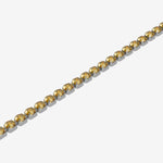 Gold bracelet with yellow gemstones on a white background