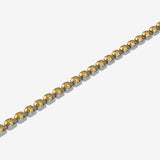 Gold bracelet with yellow gemstones on a white background