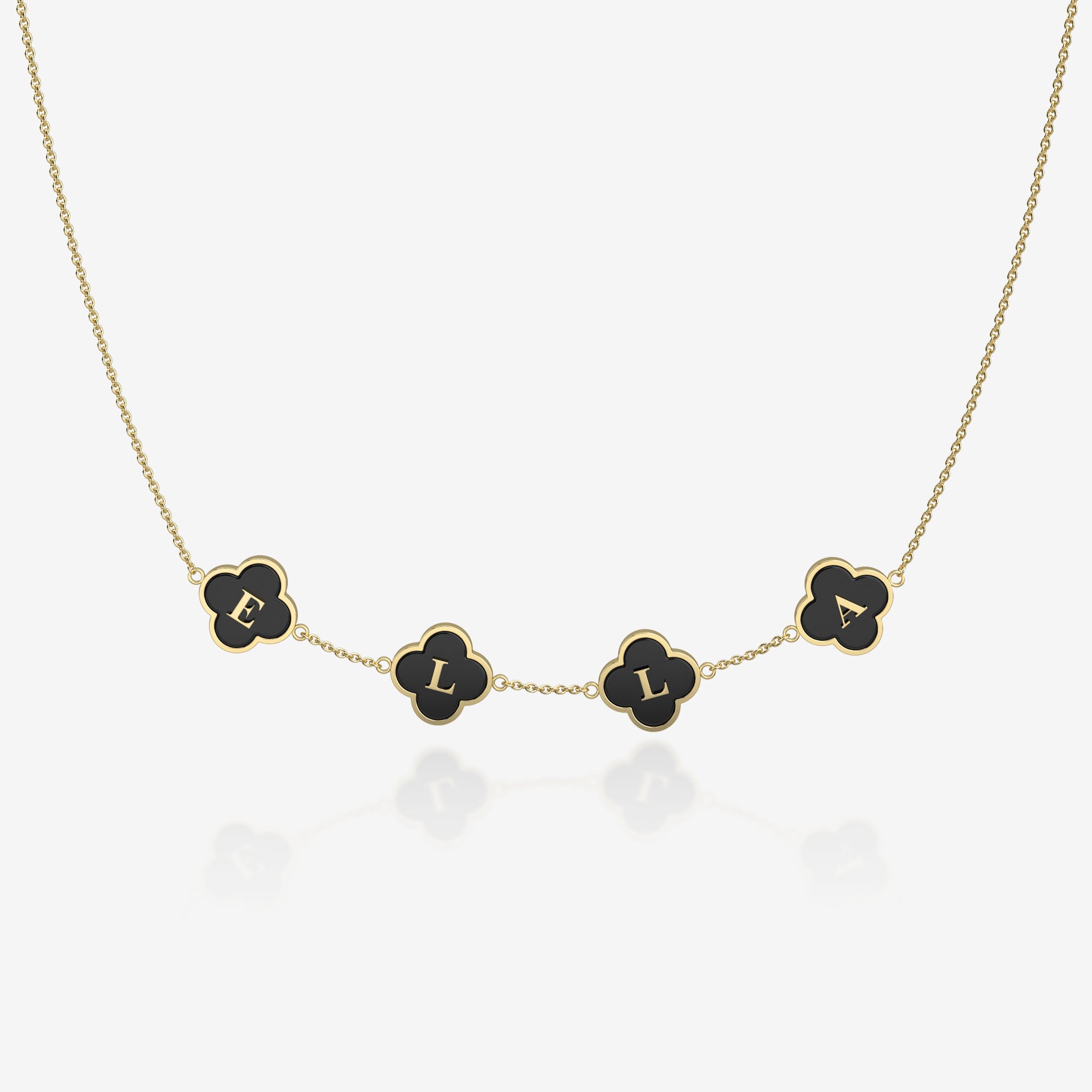 Gold necklace with black clover-shaped pendants on a white background
