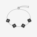 Bracelet with black clover shaped charms displaying letters on a white background