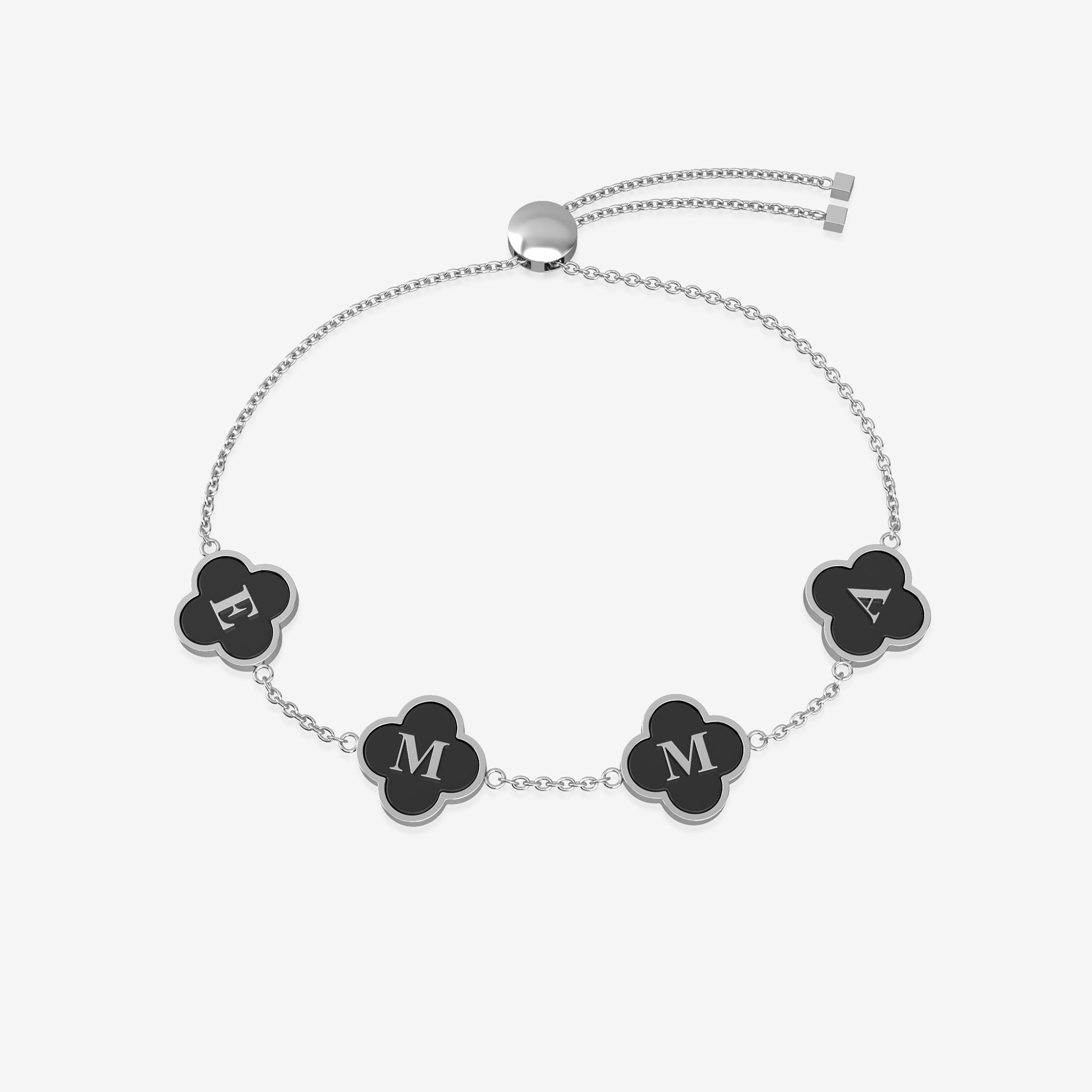 Bracelet with black clover shaped charms displaying letters on a white background