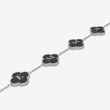 Bracelet with black clover-shaped charms featuring initials on a white background