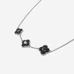 Silver Necklace with black clover-shaped pendants with initials on a white background