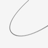 Silver chain necklace on a light gray background