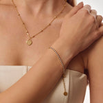 Gold tennis bracelet on model and white background