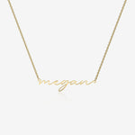Gold necklace with 'megan' pendant on a white background
