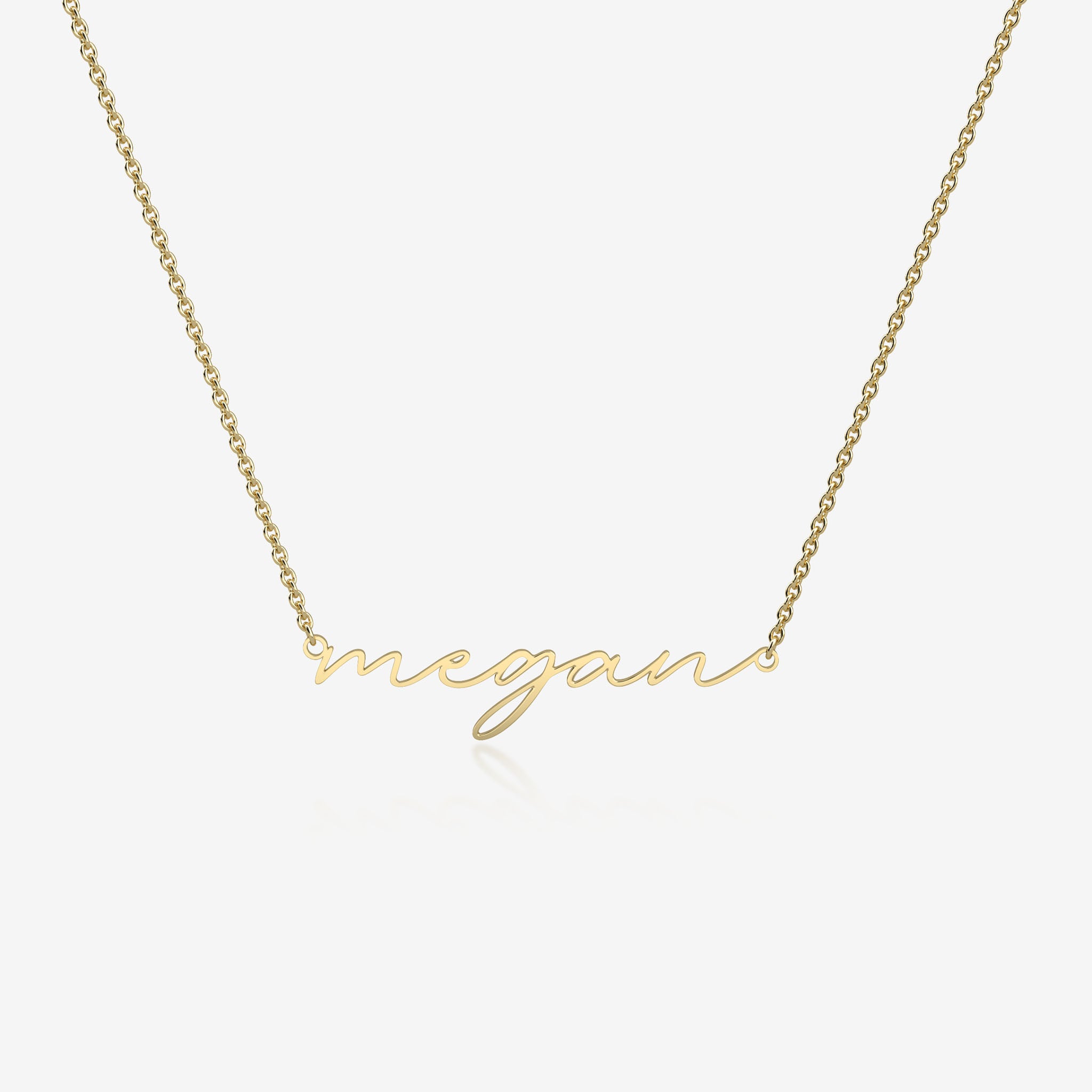 Gold necklace with 'megan' pendant on a white background