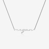 Silver necklace with 'megan' pendant on a white background