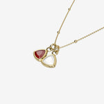 Gold necklace with triangle-shaped birthstone pendants on a white background