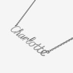 Silver necklace with 'Charlotte' pendant on a white background