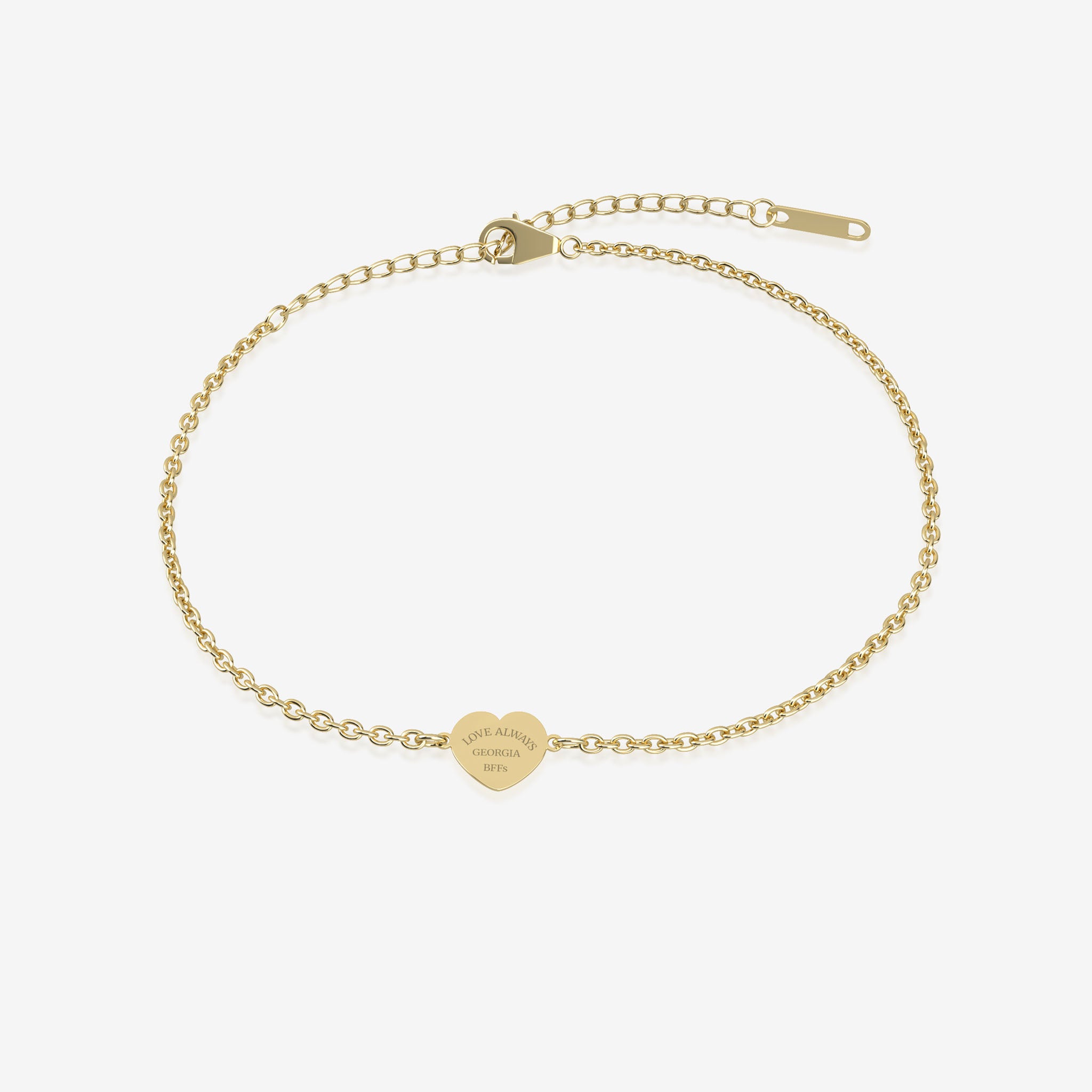 Gold bracelet with a heart-shaped tag with engraving on a white background