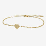 Gold bracelet with a heart-shaped tag with engraving on a white background