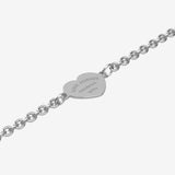 Silver bracelet with a heart-shaped tag with engraving on a white background