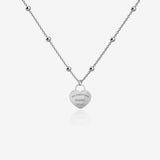 Silver necklace with a heart-shaped pendant with engraving on a white background