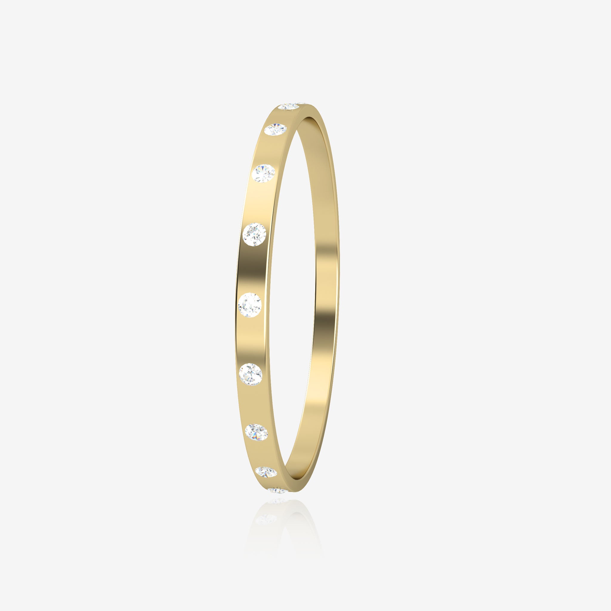 Gold bangle with embedded diamonds on a light beige background