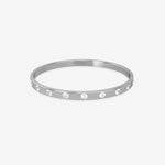 Silver bangle with embedded stones on a white background