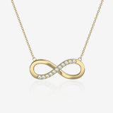 Gold infinity necklace with diamonds on a light beige background