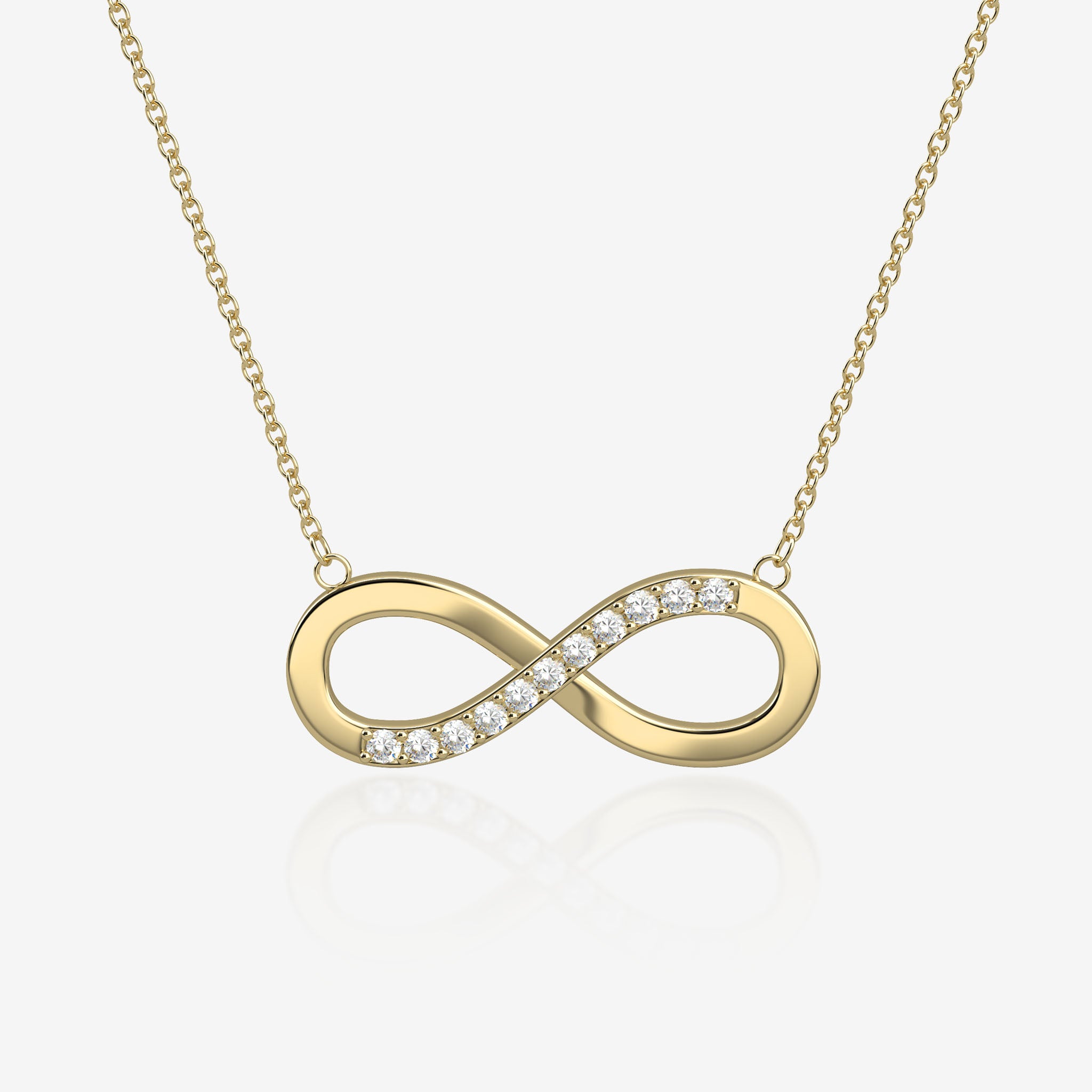 Gold infinity necklace with diamonds on a light beige background