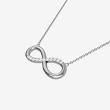 Silver infinity pendant necklace on a white background