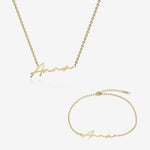 Gold name necklace and bracelet set with 'Anna' engraving on a white background