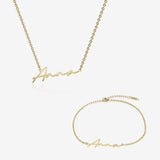 Gold name necklace and bracelet set with 'Anna' engraving on a white background