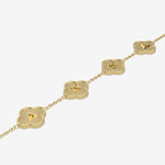 Gold necklace with clover-shaped pendants displaying initials on a white background