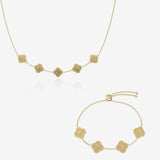 Gold clover name necklace and bracelet set on white background
