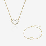 Gold heart-shaped necklace and bracelet on a white background