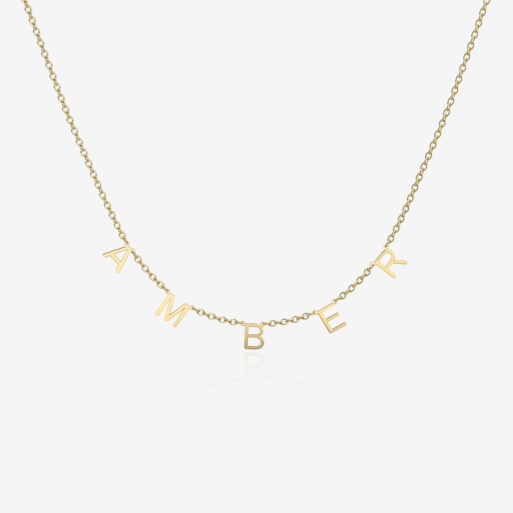 Gold necklace with 'AMBER' initial spread across the chain on a white background