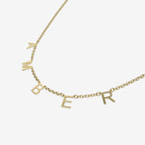 Gold necklace with 'AMBER' initials spread acorss the chain on a white background