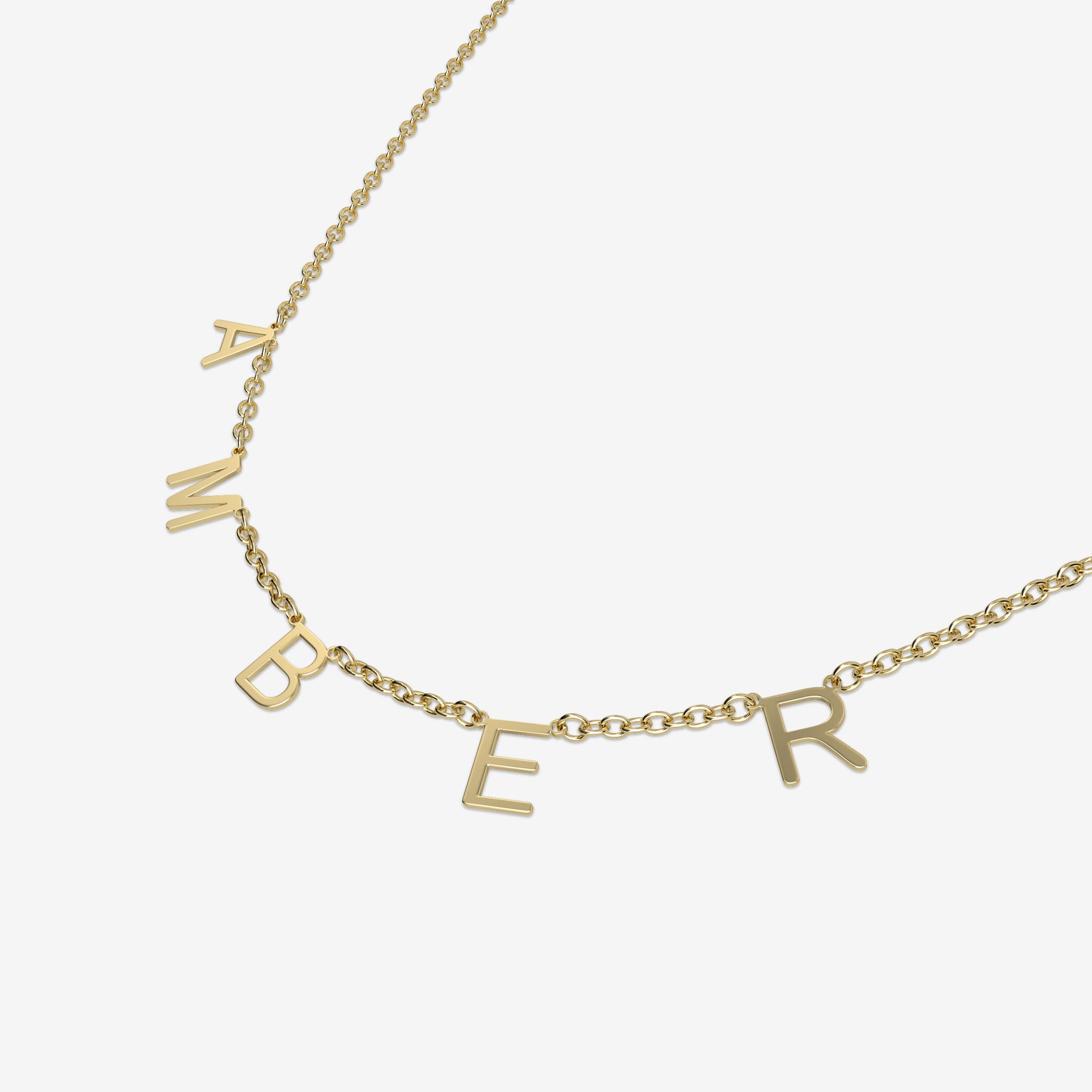 Gold necklace with 'AMBER' initials spread acorss the chain on a white background