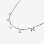 Silver necklace with 'AMBER' initials spread across the chain on a light gray background