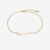 Gold bracelet with 'Mama' inscription on a white background