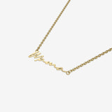 Gold necklace with 'Mama' pendant on a white background