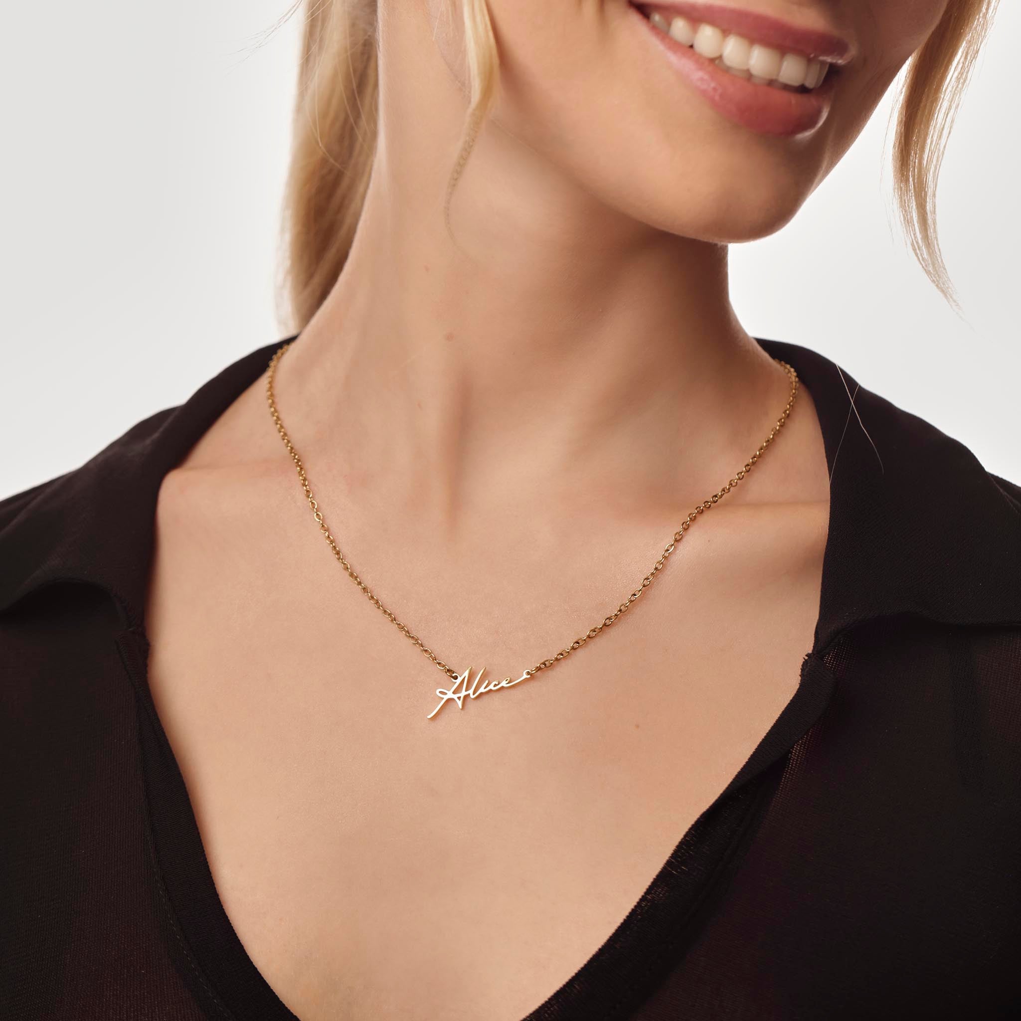 Gold necklace with 'Alice' name on a model against a neutral background