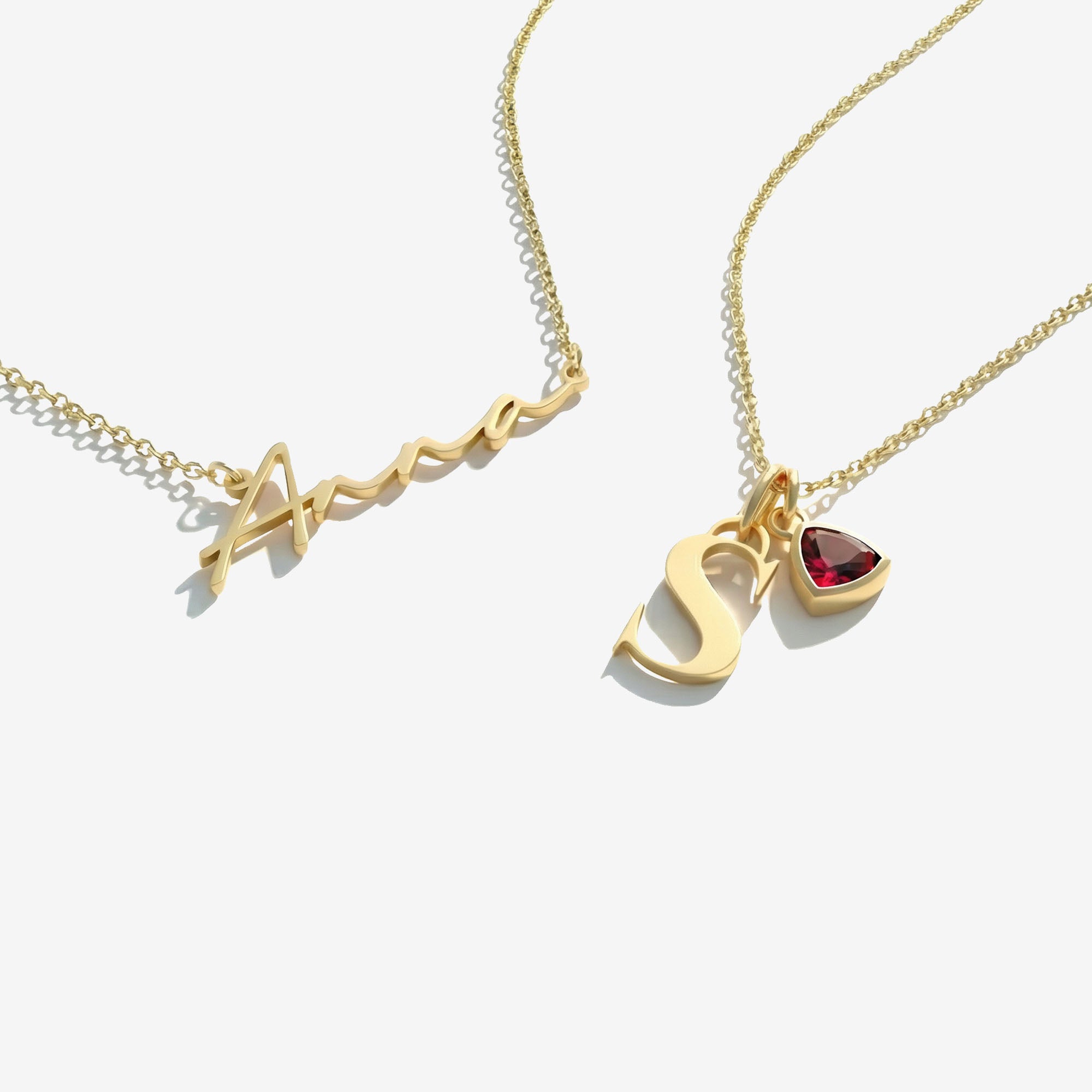 Two gold necklaces on a white background