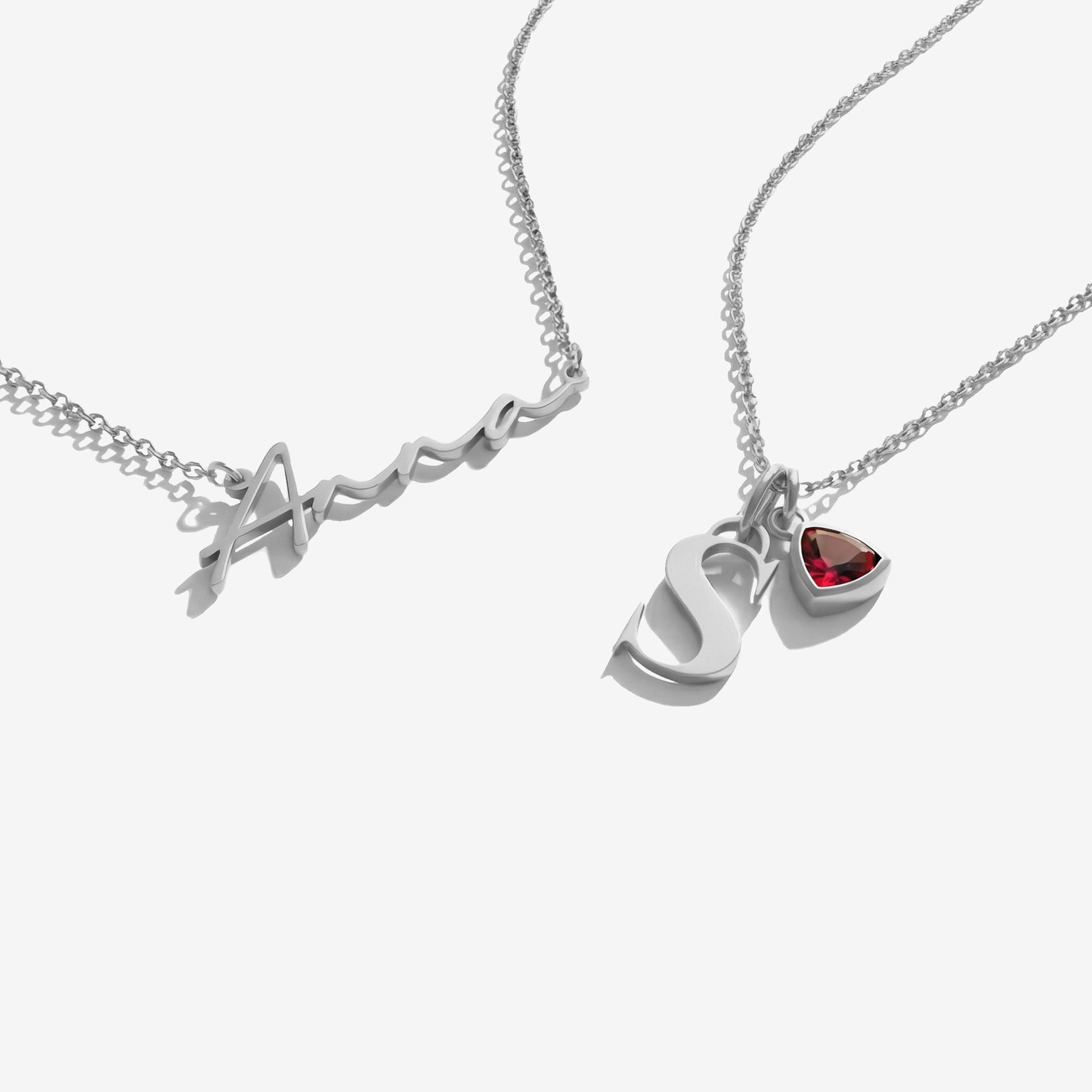 Two silver necklaces with heart-shaped pendants on a white background