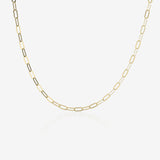 Gold paperclip chain necklace on a white background