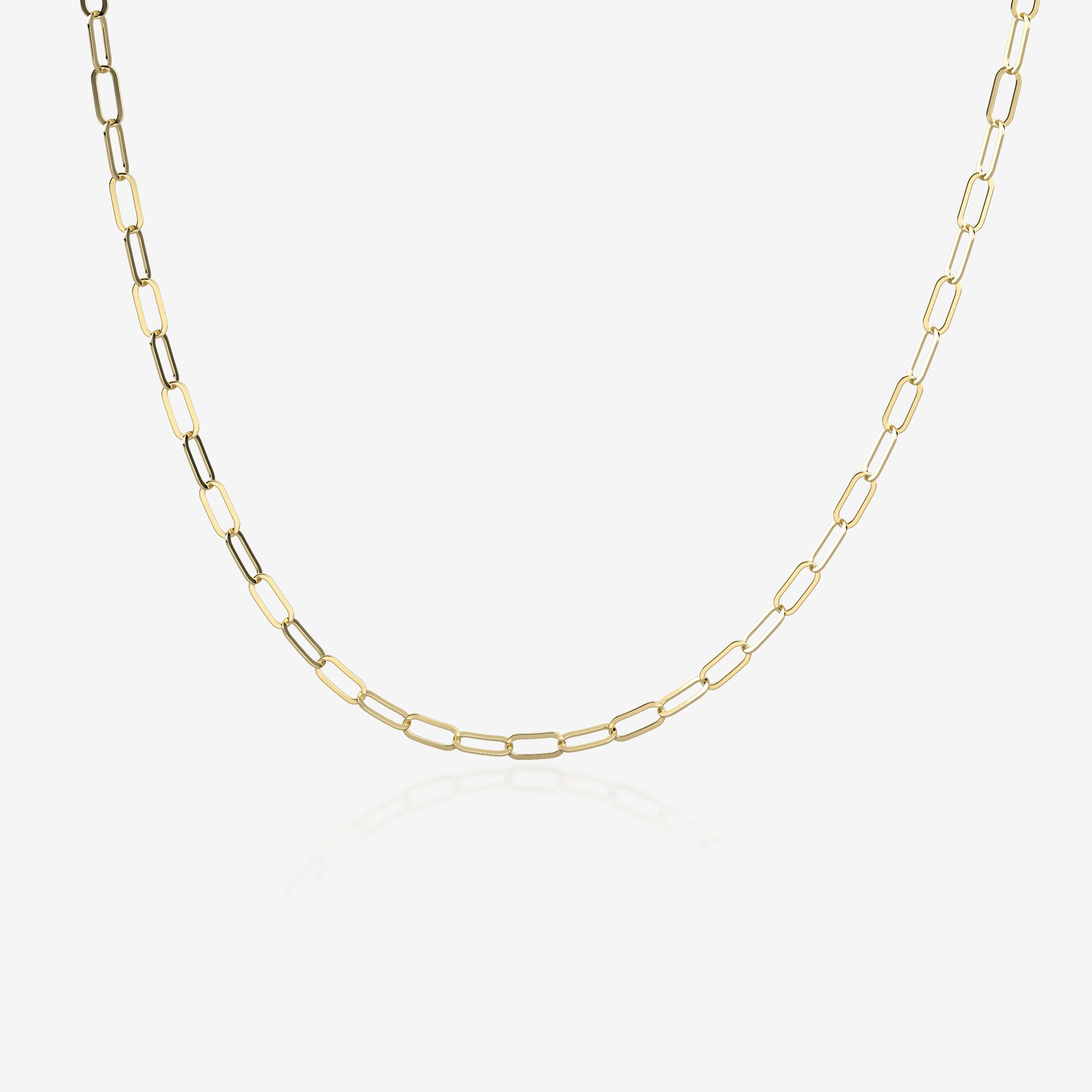 Gold paperclip chain necklace on a white background