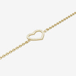 Gold bracelet with a heart-shaped clasp on a light gray background