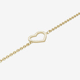 Gold bracelet with a heart-shaped clasp on a light gray background