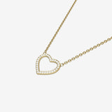 Gold heart-shaped necklace with white quartz stones on a white background