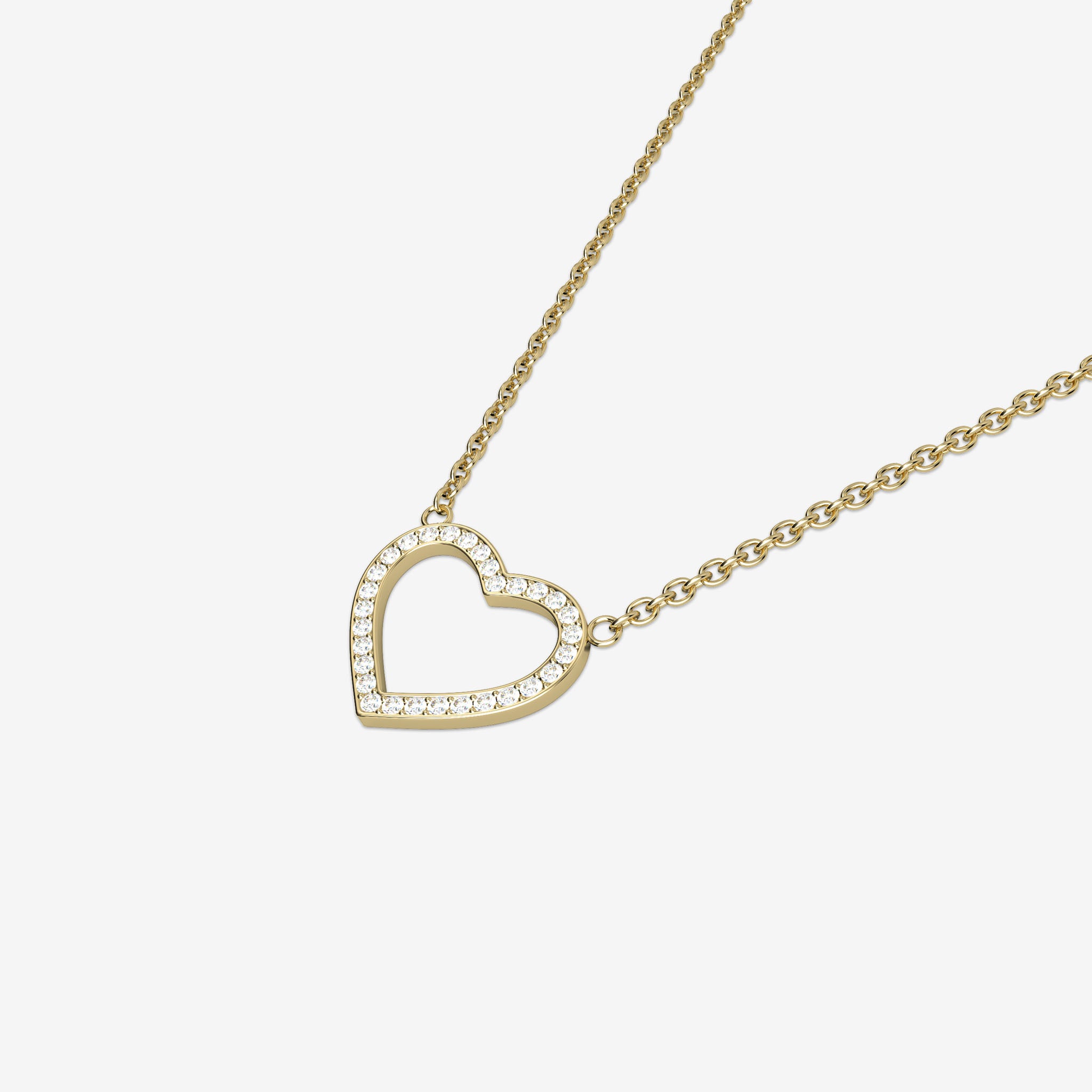 Gold heart-shaped necklace with white quartz stones on a white background