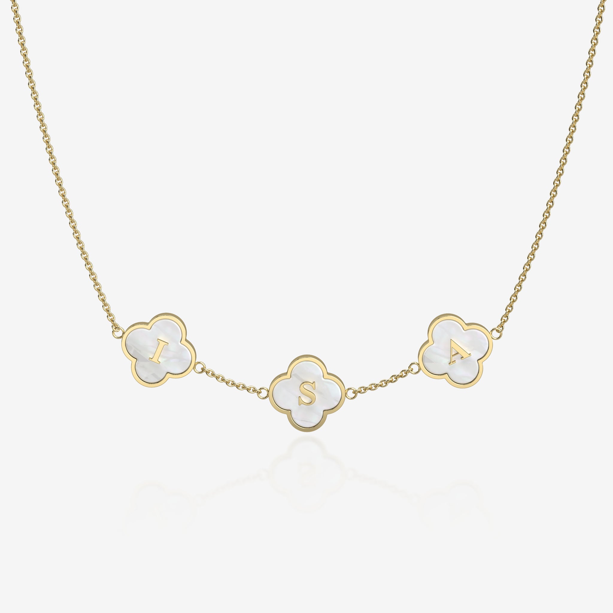 Gold necklace with clover-shaped pendants displaying letters on a white background