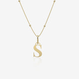 Gold necklace with a 'S' pendant on a white background
