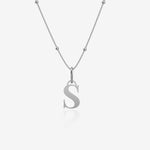 Silver necklace with a 'S' pendant on a light gray background